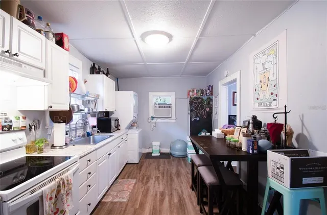 a kitchen with sink stove and chairs