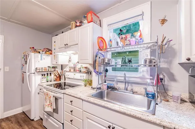 a kitchen with stainless steel appliances granite countertop a sink and dishwasher