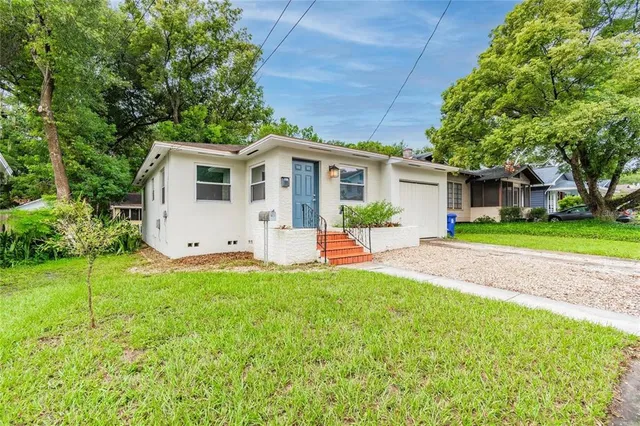 a front view of house with yard and green space