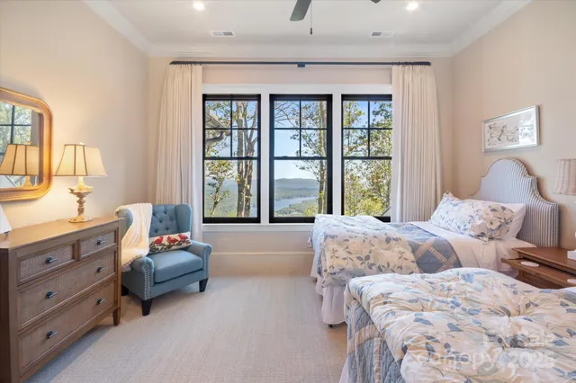 a spacious bedroom with two beds and large window