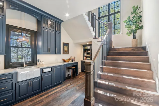 a living room with a large window and a wooden floor