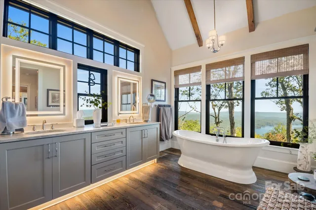 a spacious bathroom with a mirror and a sink