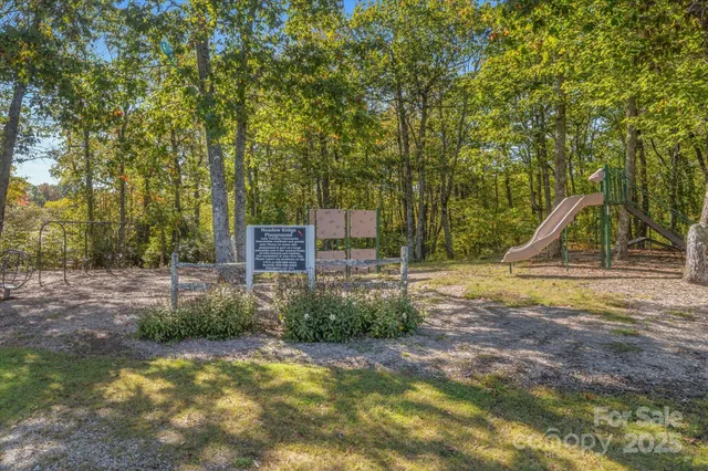 a view of a lake with a bench and trees around