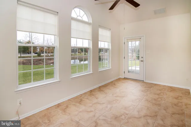 an empty room with windows and closet