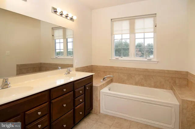 a bathroom with a granite countertop toilet and a shower