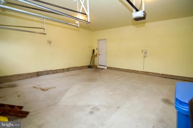 a view of a white house with a big yard and large trees