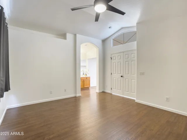 a spacious bathroom with a granite countertop sink a mirror and a shower
