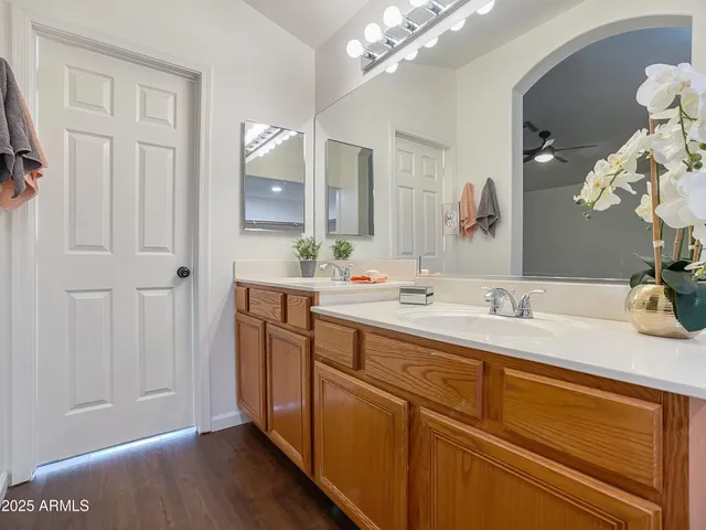 a bathroom with a granite countertop sink a large mirror and a bathtub