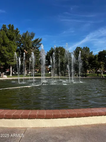 a view of a livingroom with wooden floor and staircase