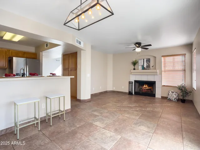 a metallic refrigerator freezer sitting in a kitchen