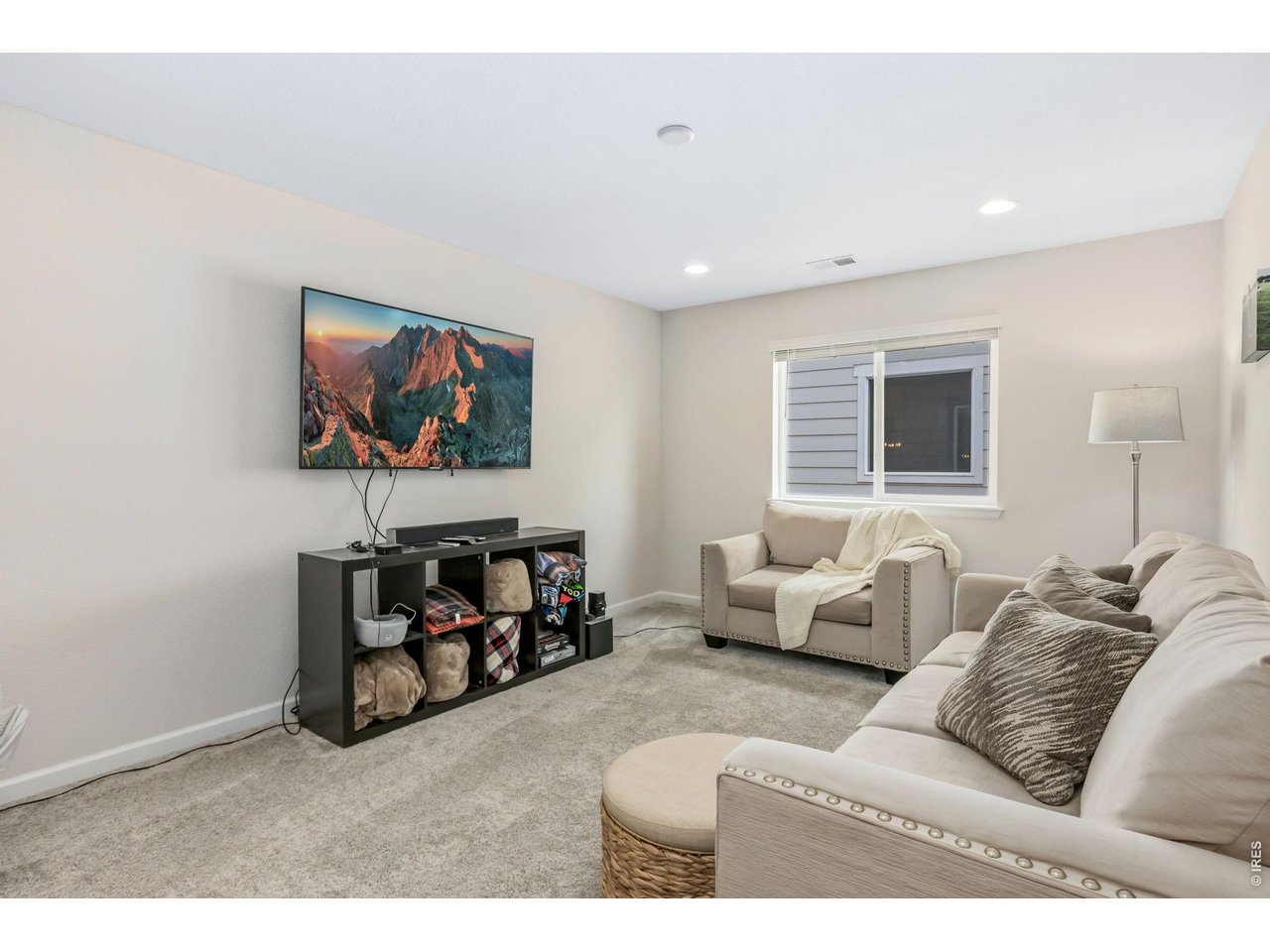 955 Rustling Street Windsor, CO 80550 - Photo 20 of 34 a living room with furniture and a flat screen tv