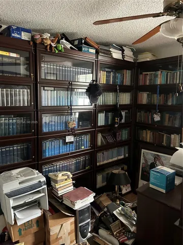 a work room with furniture and a book shelf