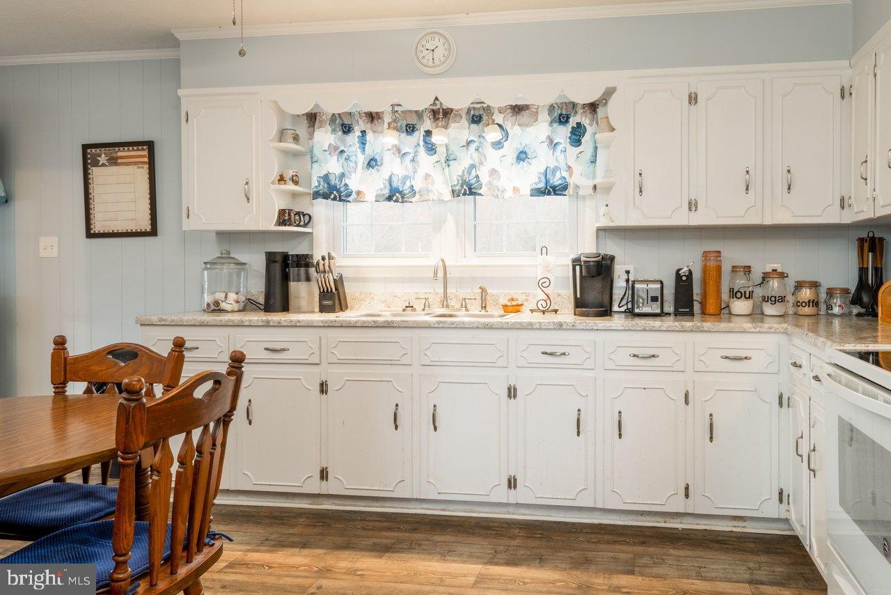 1204 Battle Creek Road Stanley, VA 22851 - Photo 12 of 46 a kitchen with white cabinets and sink