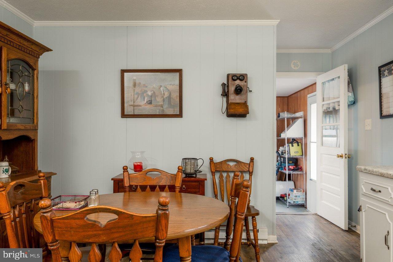1204 Battle Creek Road Stanley, VA 22851 - Photo 18 of 46 a view of a dining room with furniture and wooden floor