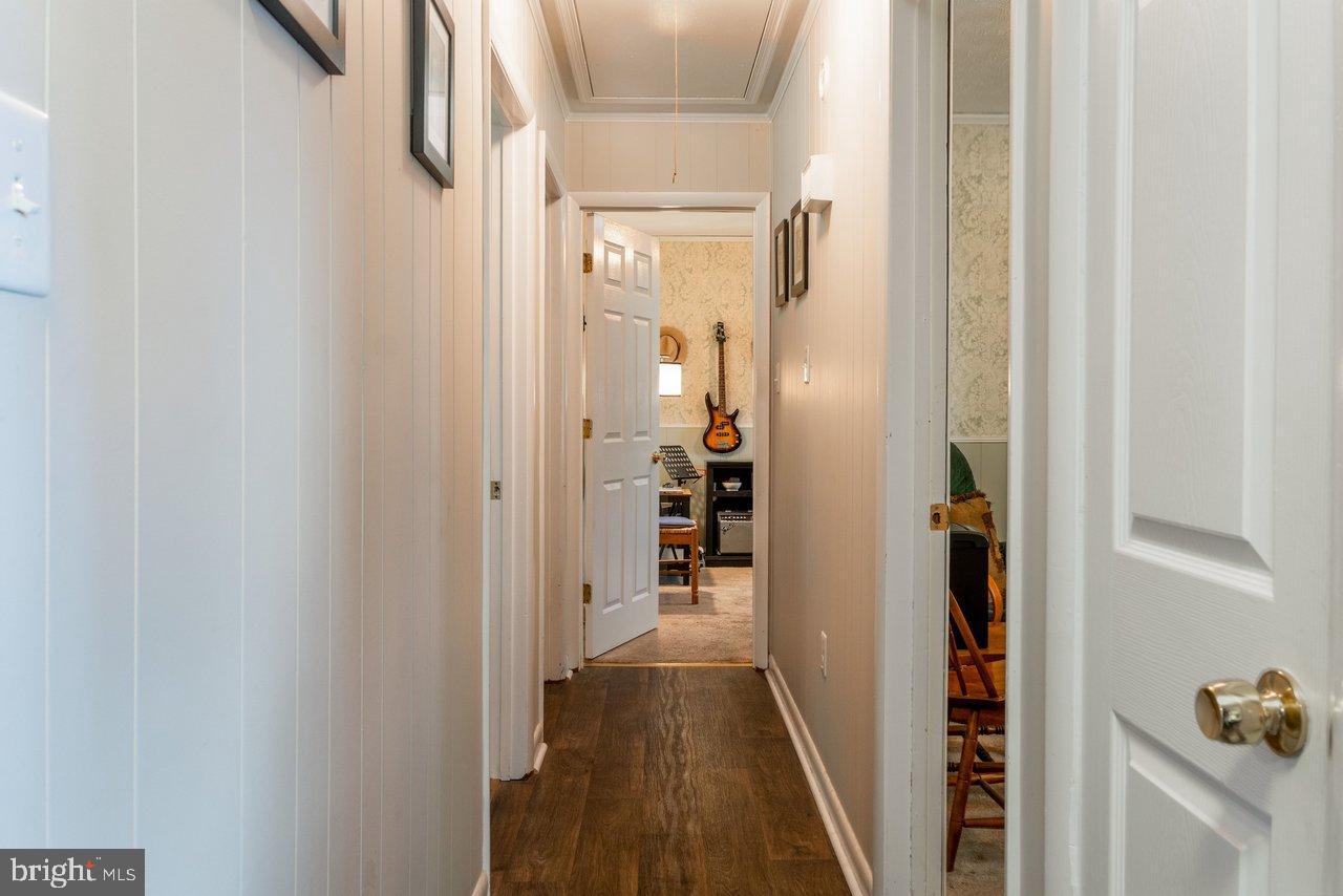 1204 Battle Creek Road Stanley, VA 22851 - Photo 19 of 46 a view of a hallway with wooden floor and closet