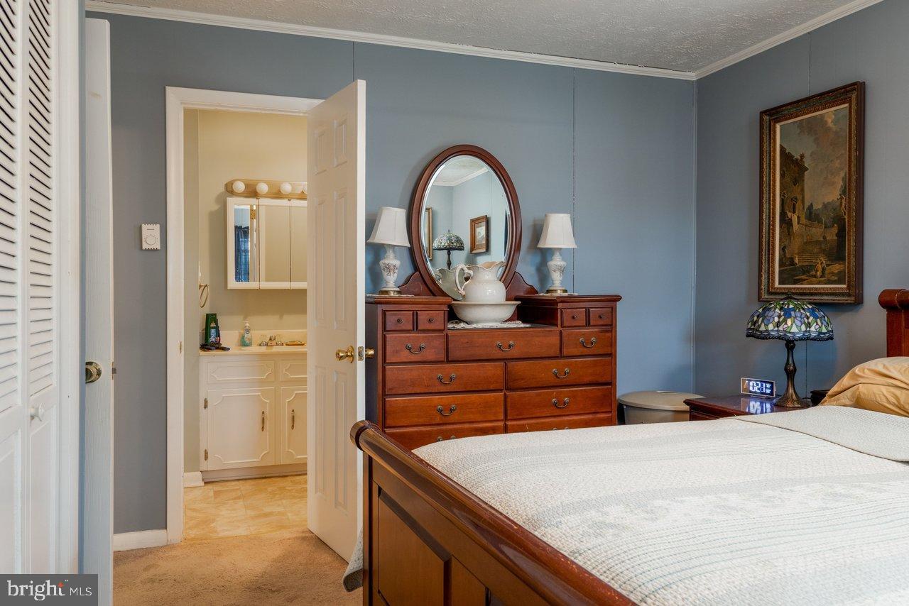 1204 Battle Creek Road Stanley, VA 22851 - Photo 22 of 46 a bedroom with a bed and a dresser
