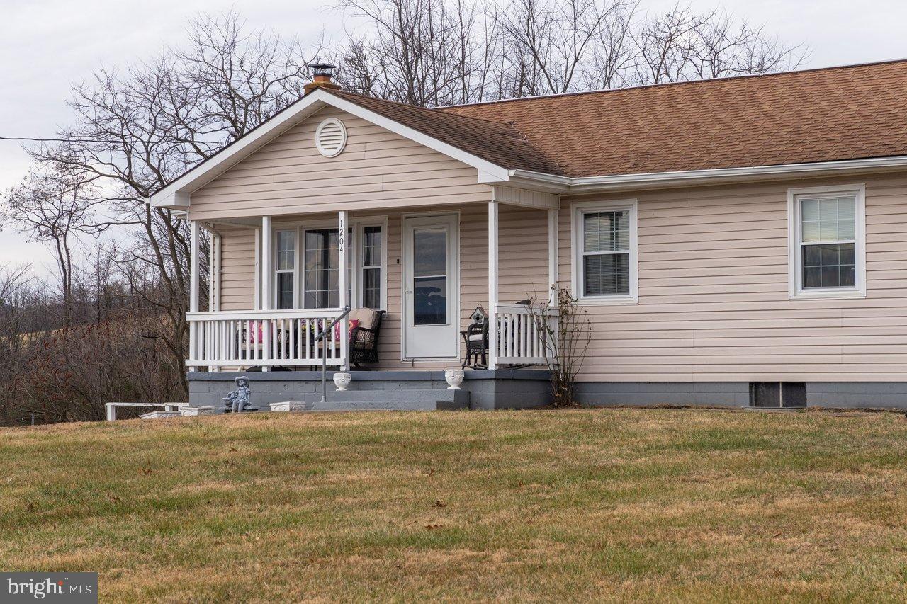 1204 Battle Creek Road Stanley, VA 22851 - Photo 4 of 46 a front view of a house with garden
