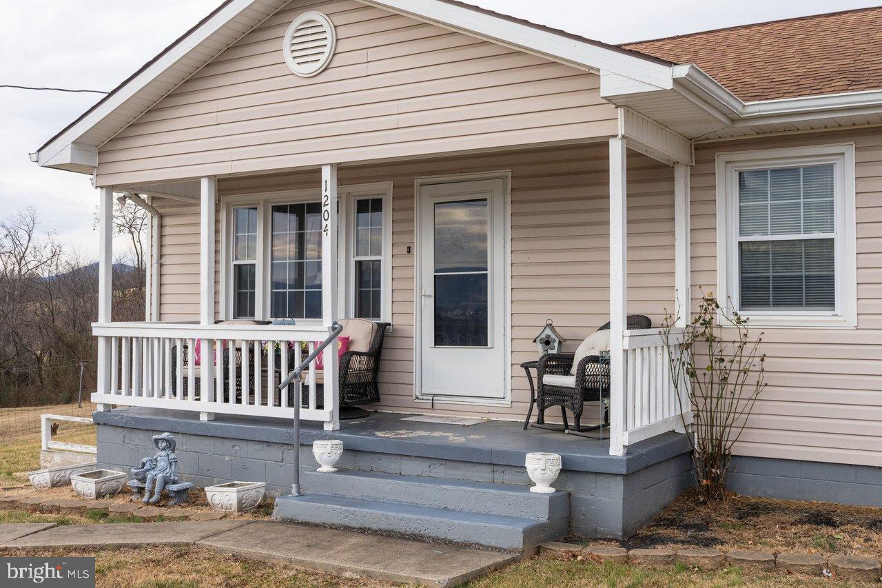 1204 Battle Creek Road Stanley, VA 22851 - Photo 44 of 46 a view of a house with two chairs and a table in patio