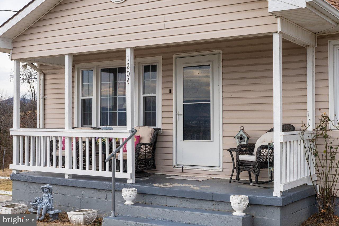 1204 Battle Creek Road Stanley, VA 22851 - Photo 5 of 46 a view of a chair and a table in the balcony