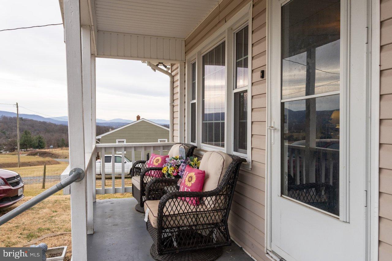 1204 Battle Creek Road Stanley, VA 22851 - Photo 6 of 46 a view of a balcony filled with furniture