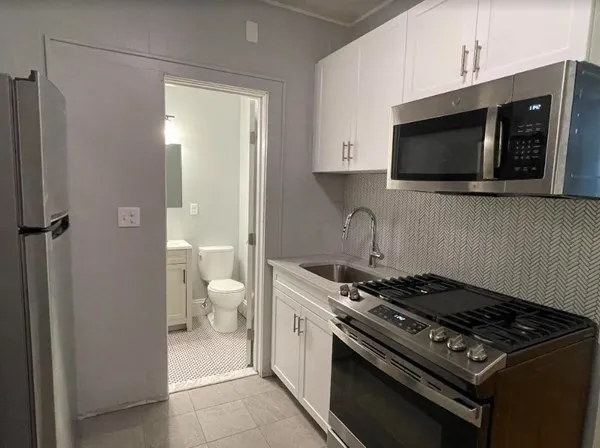 a kitchen with a stove and a microwave