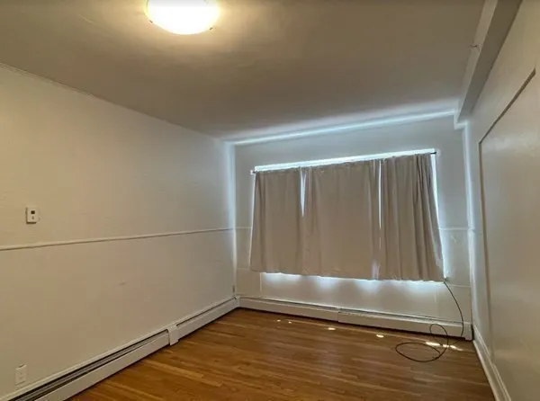 a view of a room with wooden floor