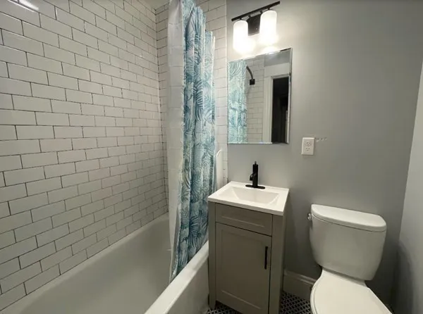 a bathroom with a toilet sink and mirror
