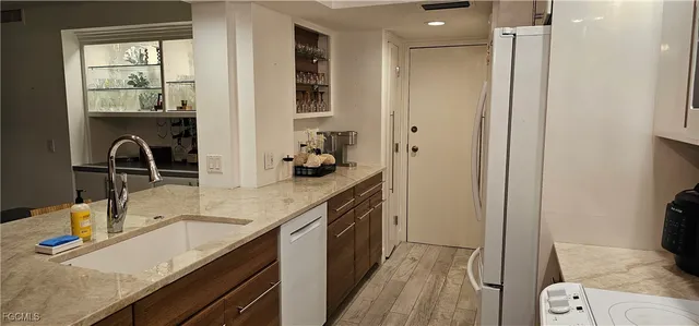 a living room with furniture a rug and a mirror