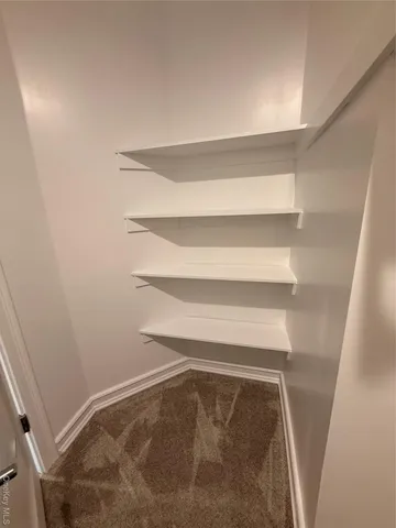 a bathroom with a sink mirror vanity and toilet