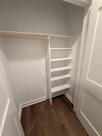 a view of walk in closet with empty racks