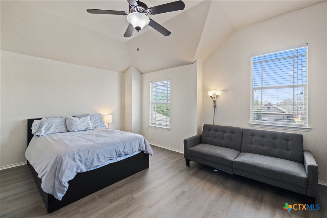 10113 Copper Ridge Cove Austin, TX 78747 - Photo 15 of 32 a bedroom with a bed couch and window
