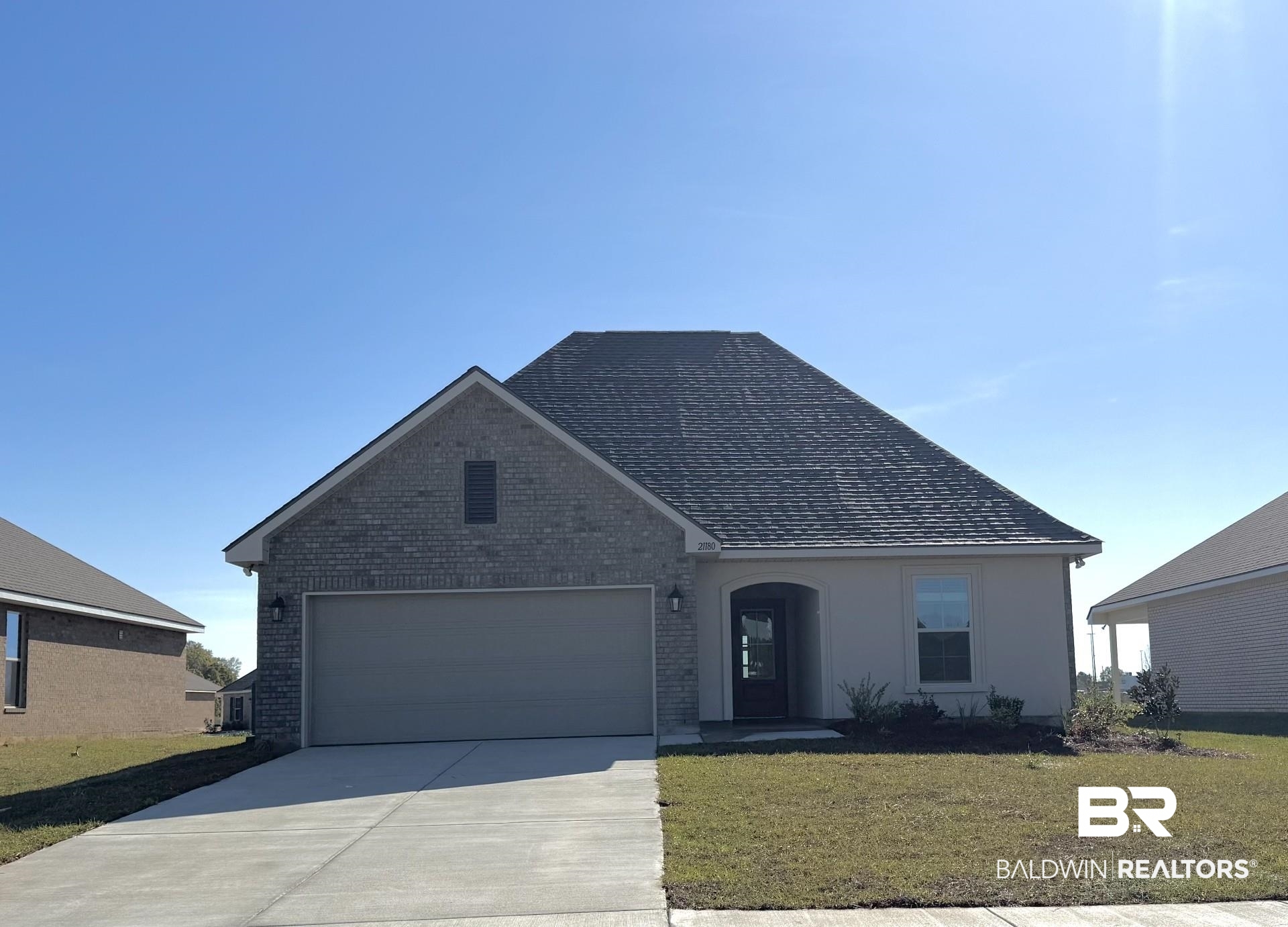 21180 Explorer Drive Robertsdale, AL 36567 - Photo 1 of 3 Single story home with a front yard, a garage, brick siding, and concrete driveway