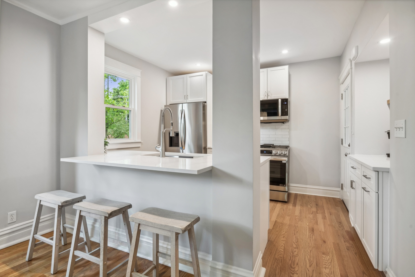 2429 Central Street Evanston, IL 60201 - Photo 12 of 34 a kitchen with white cabinets and wooden floor