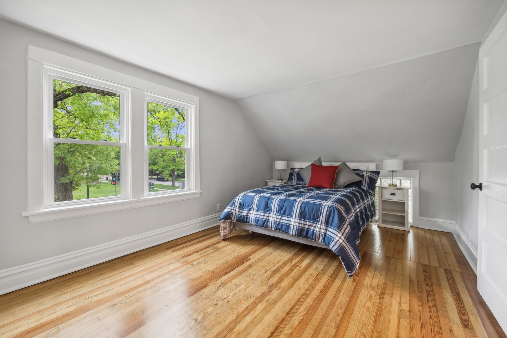 2429 Central Street Evanston, IL 60201 - Photo 18 of 34 a bedroom with a bed and wooden floor