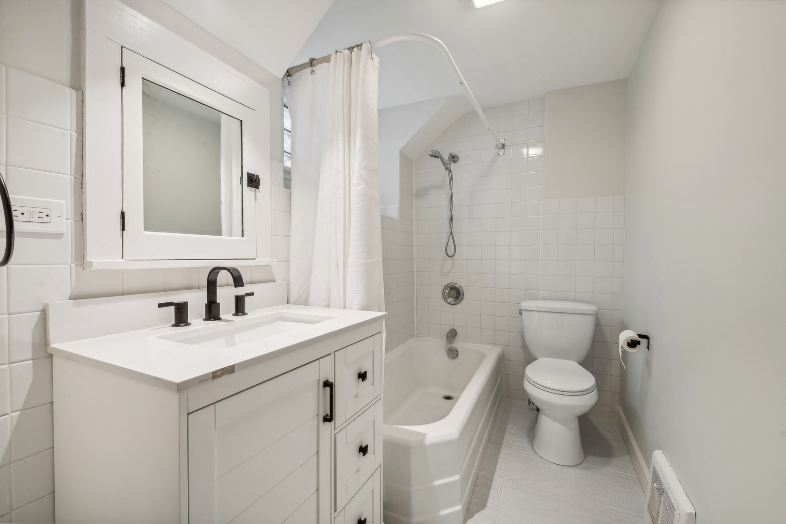 2429 Central Street Evanston, IL 60201 - Photo 24 of 34 a bathroom with a sink toilet vanity and shower
