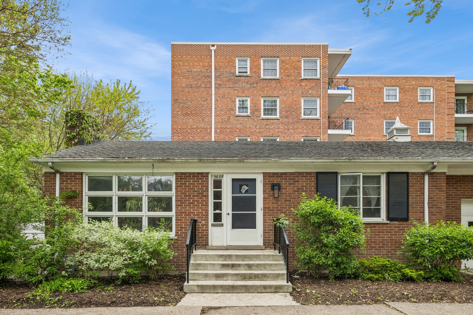 2429 Central Street Evanston, IL 60201 - Photo 4 of 34 a front view of a building with garden and windows