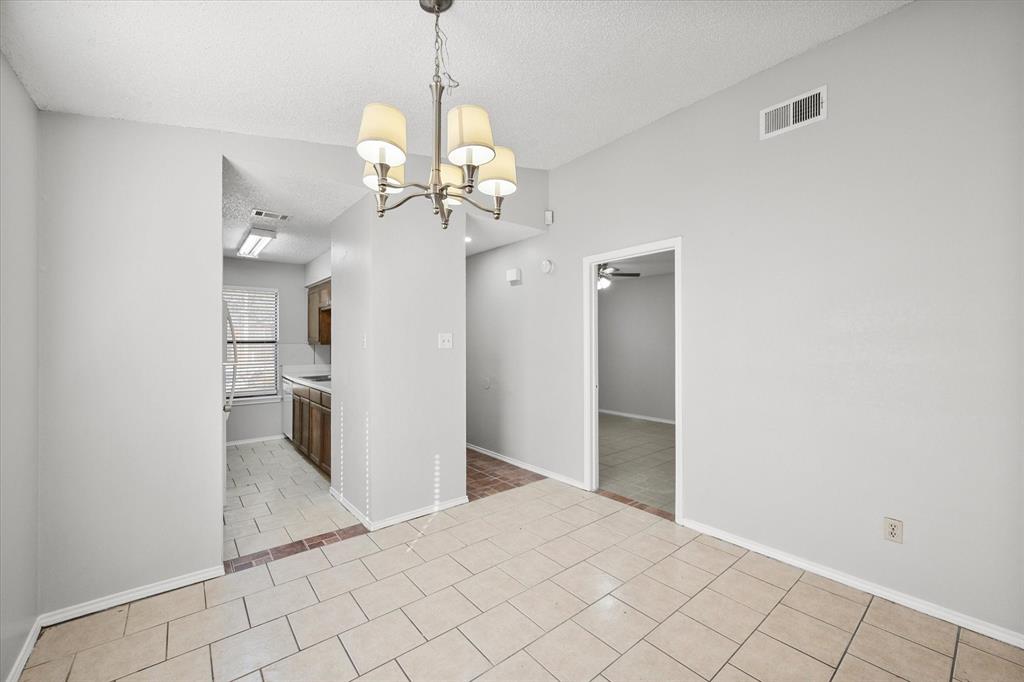 5821 Mansfield Road Arlington, TX 76017 - Photo 8 of 24 a view of a kitchen with a sink and chandelier