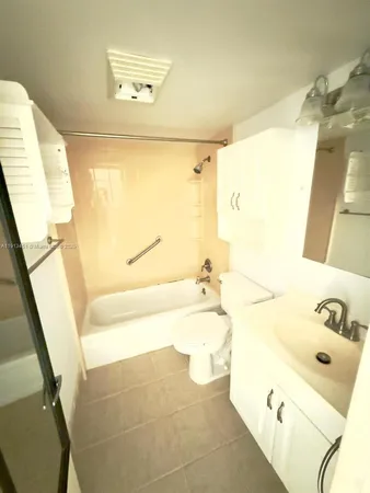 a bathroom with a bathtub sink and a toilet