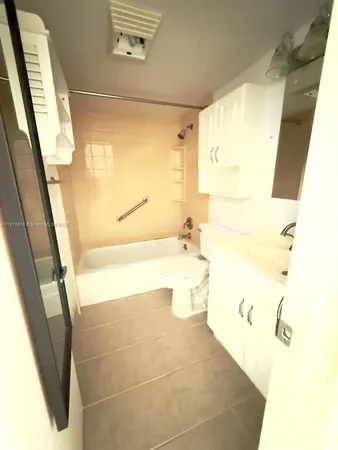 a bathroom with a bathtub sink and toilet