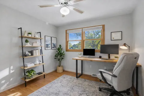 a workspace with furniture window and wooden floor