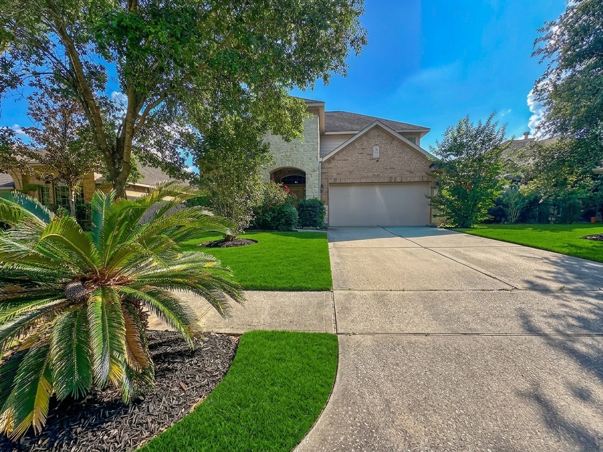 20319 Little Wing Drive Spring, TX 77388 - Photo 1 of 49 a front view of a house with a garden and entryway