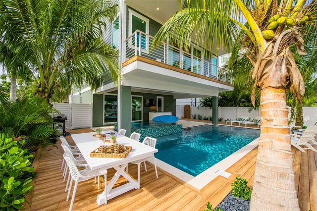 a view of a house with backyard and sitting area