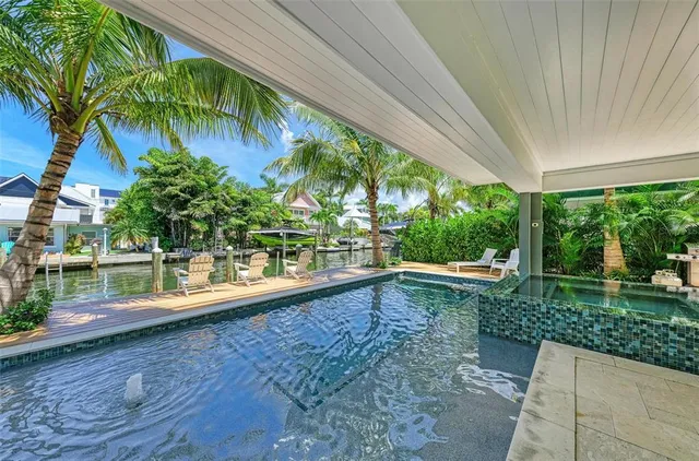an aerial view of a house with an outdoor space and seating