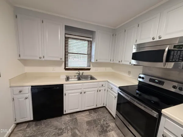 a kitchen with a sink stove and cabinets