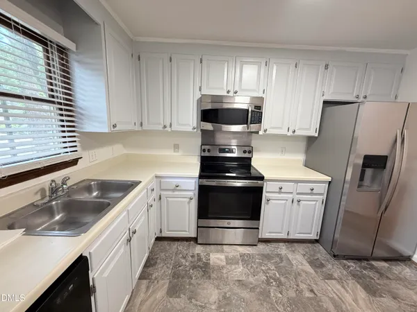 a kitchen with a sink stove and refrigerator