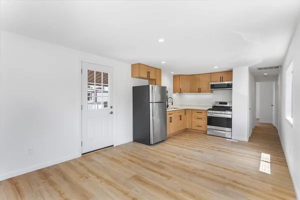 a kitchen with stainless steel appliances a refrigerator and a stove top oven