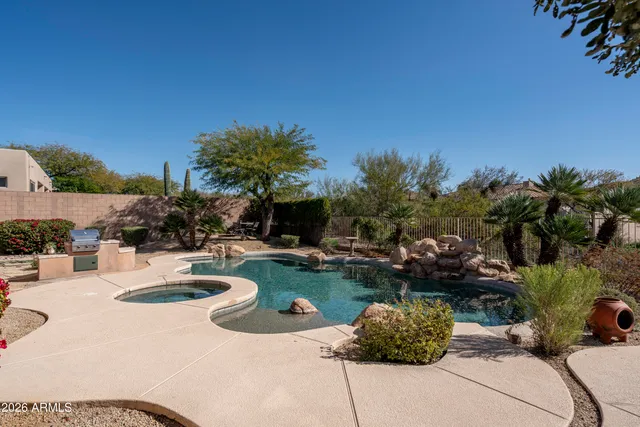a view of a house with swimming pool and a chairs in patio