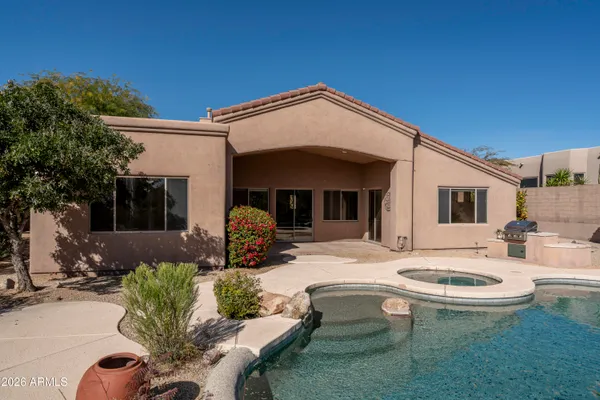 a view of a house with swimming pool and sitting area