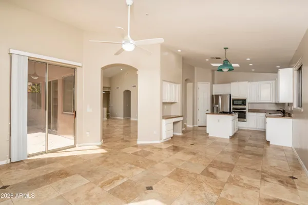 a view of a kitchen with refrigerator and a stove top oven