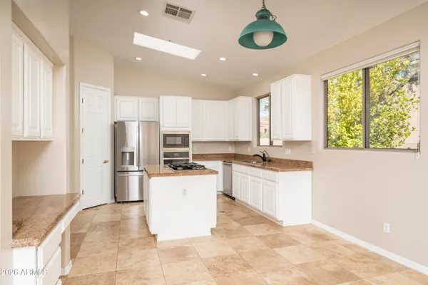 a kitchen with a refrigerator and a sink